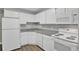 Efficient kitchen with sleek white appliances and granite countertops at 195 S Sable Blvd # U12, Aurora, CO 80012
