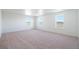 An empty bedroom with carpet and three windows at 9882 Cathay St, Commerce City, CO 80022