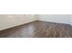 Bright bedroom with hardwood floors, white walls, and natural light streaming through windows at 9882 Cathay St, Commerce City, CO 80022