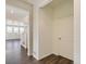 Bright entryway featuring hardwood floors, an interior door, and a view to the stairs and living area at 9882 Cathay St, Commerce City, CO 80022