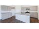 A kitchen with grey cabinets, stainless steel appliances, an island, and granite countertops at 9882 Cathay St, Commerce City, CO 80022