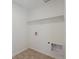 Functional laundry room with hookups and shelving at 9882 Cathay St, Commerce City, CO 80022