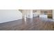 Spacious living area featuring stylish hardwood floors and an open layout leading to the kitchen at 9882 Cathay St, Commerce City, CO 80022
