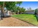 Spacious backyard featuring mature trees, a grassy lawn, playhouse, and plenty of space for outdoor activities at 1627 S Saint Paul St, Denver, CO 80210