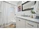 Elegant bathroom featuring a marble vanity and a shower with white subway tiles at 1627 S Saint Paul St, Denver, CO 80210