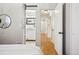 Hallway with a glimpse of a modern bathroom through a stylish barn door at 1627 S Saint Paul St, Denver, CO 80210