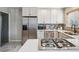 Contemporary kitchen with stainless steel appliances, white cabinets, and a sleek island cooktop at 1627 S Saint Paul St, Denver, CO 80210