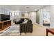 Spacious basement living room with a comfortable sectional and ample lighting at 1627 S Saint Paul St, Denver, CO 80210