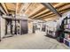 A large basement is unfinished with mechanicals, laundry, and workout equipment at 13255 Holly St # B, Thornton, CO 80241