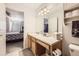 A well-lit bathroom leads to a carpeted bedroom with decor and a view to the backyard at 13255 Holly St # B, Thornton, CO 80241