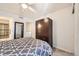This bedroom features carpet flooring, a ceiling fan, and closet space at 13255 Holly St # B, Thornton, CO 80241