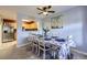 Dining area with a table set for six, a ceiling fan, and a view into the kitchen at 13255 Holly St # B, Thornton, CO 80241