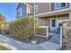 Inviting front entrance with a white door, stone accents, and a small, well-maintained yard at 13255 Holly St # B, Thornton, CO 80241