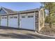 A multi-car garage features stone accents and unit numbers at 13255 Holly St # B, Thornton, CO 80241