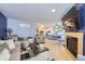 Open-concept living and dining area with a fireplace and ample natural light at 13255 Holly St # B, Thornton, CO 80241