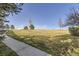 The spacious yard features a walkway, mature trees, and landscaping at 13255 Holly St # B, Thornton, CO 80241