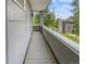 Balcony with wood-like flooring and a railing, offering a view of the surrounding neighborhood at 1245 Utica St # 104, Denver, CO 80204