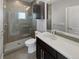 Stylish bathroom featuring a glass-enclosed shower and modern vanity with a large mirror at 1245 Utica St # 104, Denver, CO 80204