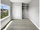 Sunlit bedroom featuring carpeted floors, built-in shelving, and ample natural light from the window at 1245 Utica St # 104, Denver, CO 80204