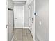 Bright hallway featuring wood-look floors, white doors, and coat hooks for organized storage at 1245 Utica St # 104, Denver, CO 80204