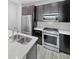 Modern kitchen with stainless steel appliances, sleek cabinets, and bright countertops at 1245 Utica St # 104, Denver, CO 80204