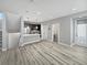 Open-concept living space with wood floors, stairs, modern kitchen and bright natural light at 1245 Utica St # 104, Denver, CO 80204