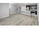 Spacious living space with modern kitchen, stainless appliances, wood-look floors and light-filled open floorplan at 1245 Utica St # 104, Denver, CO 80204