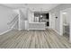 Modern living space featuring stainless appliances, wood-look flooring, and an open floor plan at 1245 Utica St # 104, Denver, CO 80204