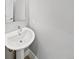 Clean and simple powder room featuring a pedestal sink, modern faucet, and neutral color scheme at 1245 Utica St # 104, Denver, CO 80204
