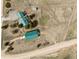 Aerial view of a home with green roofs, various buildings, and spacious grounds in a serene setting at 37653 Lark Dr, Elizabeth, CO 80107