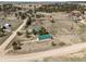 Aerial view of a sprawling property with multiple buildings and surrounding trees at 37653 Lark Dr, Elizabeth, CO 80107