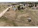 Aerial view of a property with several buildings, mature trees, and a sprawling landscape at 37653 Lark Dr, Elizabeth, CO 80107