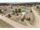 Aerial view of a large property with multiple buildings, trees, and open land at 37653 Lark Dr, Elizabeth, CO 80107