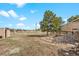 Expansive backyard with a concrete patio and lush trees, perfect for outdoor activities and relaxation at 37653 Lark Dr, Elizabeth, CO 80107