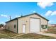 Large barn with a white door and green trim, situated on a vast lot under a blue sky at 37653 Lark Dr, Elizabeth, CO 80107