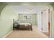 Green bedroom featuring a bed with floral covers, a window and an arched doorway at 37653 Lark Dr, Elizabeth, CO 80107
