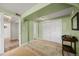 Green bedroom with a vintage rug, a built in storage nook, a closet, and two entry doors at 37653 Lark Dr, Elizabeth, CO 80107