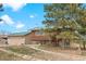 Charming log-sided home with a well-maintained yard, rock pathway, and a detached garage at 37653 Lark Dr, Elizabeth, CO 80107