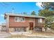 Charming home with log siding, stone accents, and a metal roof under a bright blue sky at 37653 Lark Dr, Elizabeth, CO 80107