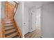 Hallway featuring a wooden staircase and white paneled doors leading to various rooms at 37653 Lark Dr, Elizabeth, CO 80107