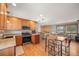 A well-lit kitchen flows into the living area, featuring granite counters and stainless steel appliances at 37653 Lark Dr, Elizabeth, CO 80107