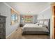 Neutral Primary bedroom featuring windows with wood trim, a gray bed and dresser and modern accents at 37653 Lark Dr, Elizabeth, CO 80107