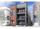 Modern three-story home featuring a stone and wood facade, multiple balconies, and professionally landscaped grounds at 16565 Peak St, Broomfield, CO 80023