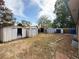 Wide backyard view featuring multiple storage sheds, partial brick patio and sparse landscaping at 10440 Gilpin St, Northglenn, CO 80233