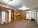 Spacious basement with wood paneled walls, a built-in bar area, and space for entertaining or storage at 10440 Gilpin St, Northglenn, CO 80233