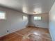 Bedroom with hardwood floors, overhead light, and multiple windows at 10440 Gilpin St, Northglenn, CO 80233