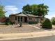 Quaint home features a manicured front yard, a fountain, and mature trees at 10440 Gilpin St, Northglenn, CO 80233