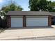 Two-car garage with white doors offers ample parking and storage at 10440 Gilpin St, Northglenn, CO 80233