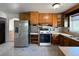 Functional kitchen with stainless steel refrigerator and tile flooring at 10440 Gilpin St, Northglenn, CO 80233