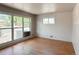 Sunlit living room with hardwood floors and large windows at 10440 Gilpin St, Northglenn, CO 80233